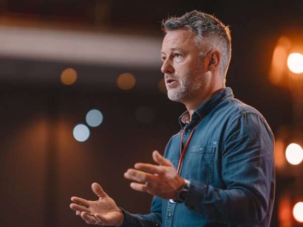 Passionate_AI_expert_speaking_on_stage_at_a_conference